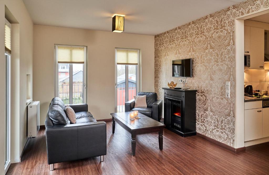 a living room with a couch and a fireplace at Scharhörn-Riff - 16 in Cuxhaven