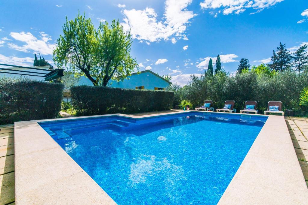 a swimming pool in a yard with chairs around it at Ideal Property Mallorca - Can Flauta in Selva