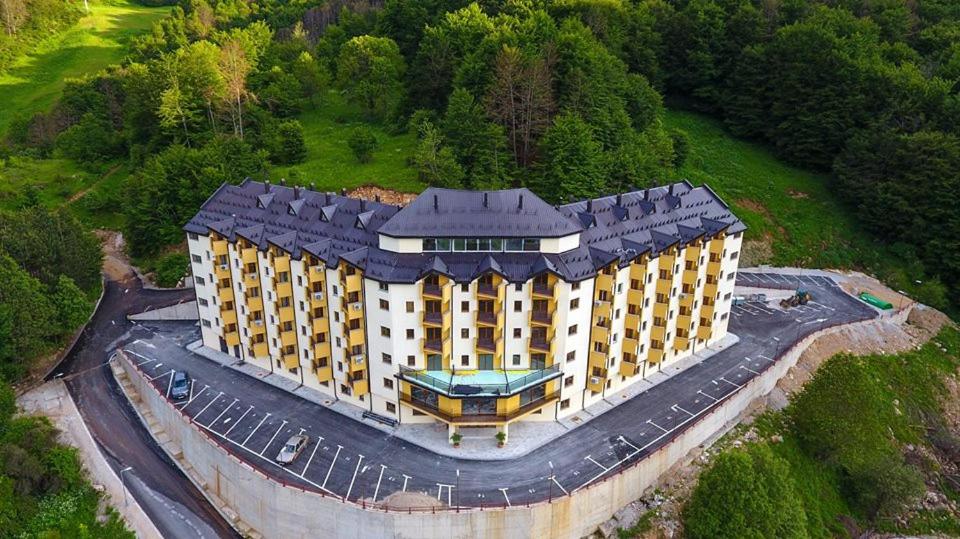 an aerial view of a large building on a hill at Apartment Invictus Mavrovo in Mavrovo