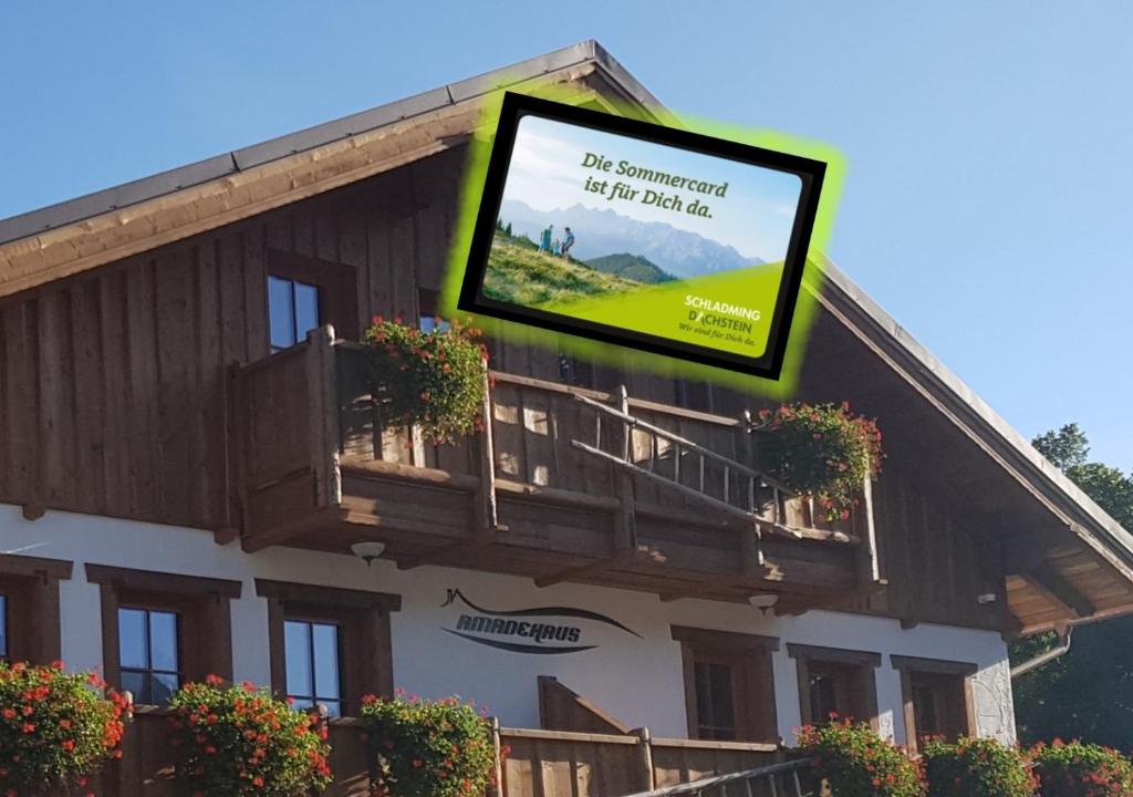 a tv on the side of a building with a balcony at Amadehaus in Pruggern