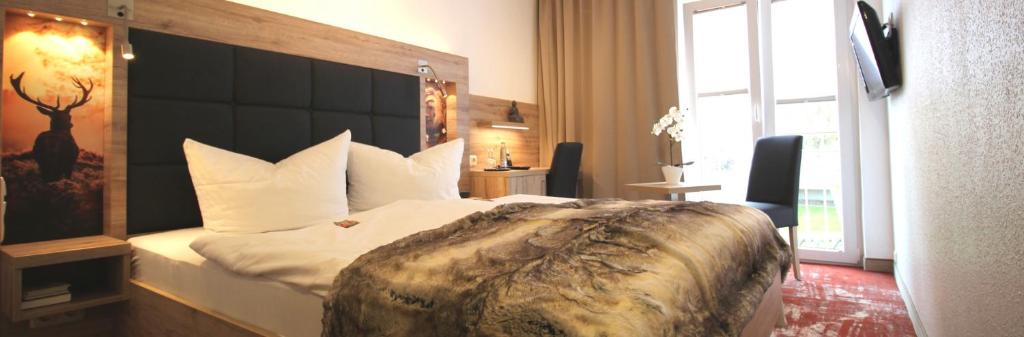Postel nebo postele na pokoji v ubytování Wellness & Ayurveda Hotel Am Eichenberg