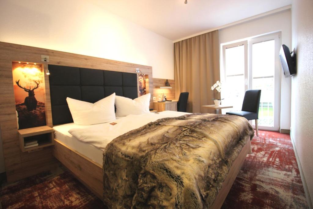 Postel nebo postele na pokoji v ubytování Wellness & Ayurveda Hotel Am Eichenberg