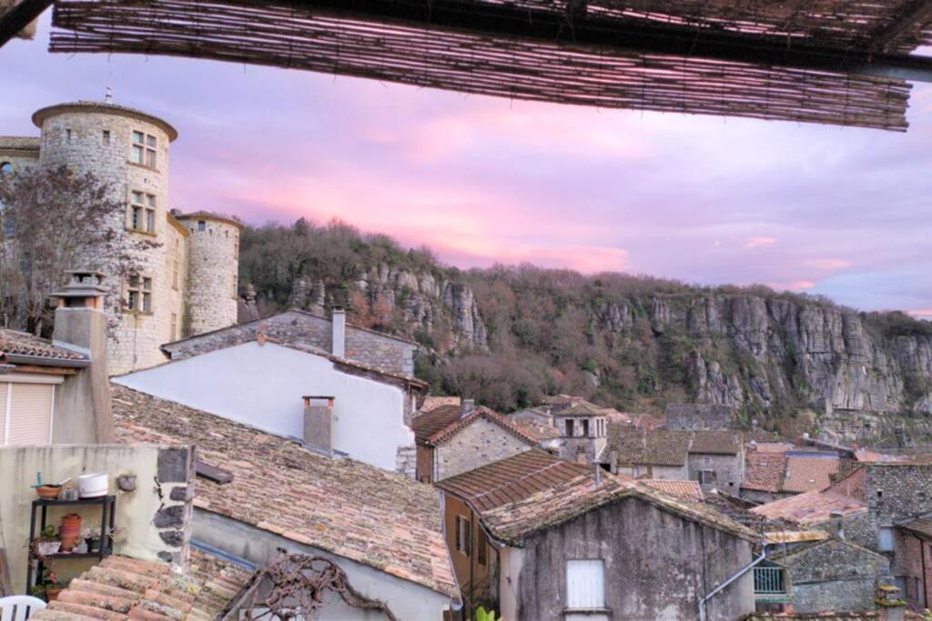 a view of a town with a mountain in the background at Vogüé meublé 2 étoiles, La plus belle vue de Vogüé in Vogüé