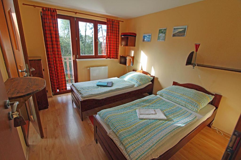 Postel nebo postele na pokoji v ubytování Chaty Tatra