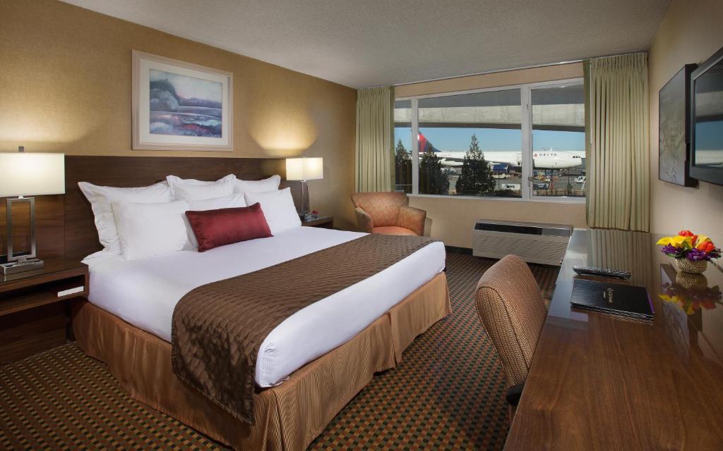 a hotel room with a large bed and a window at Coast Gateway Hotel in SeaTac