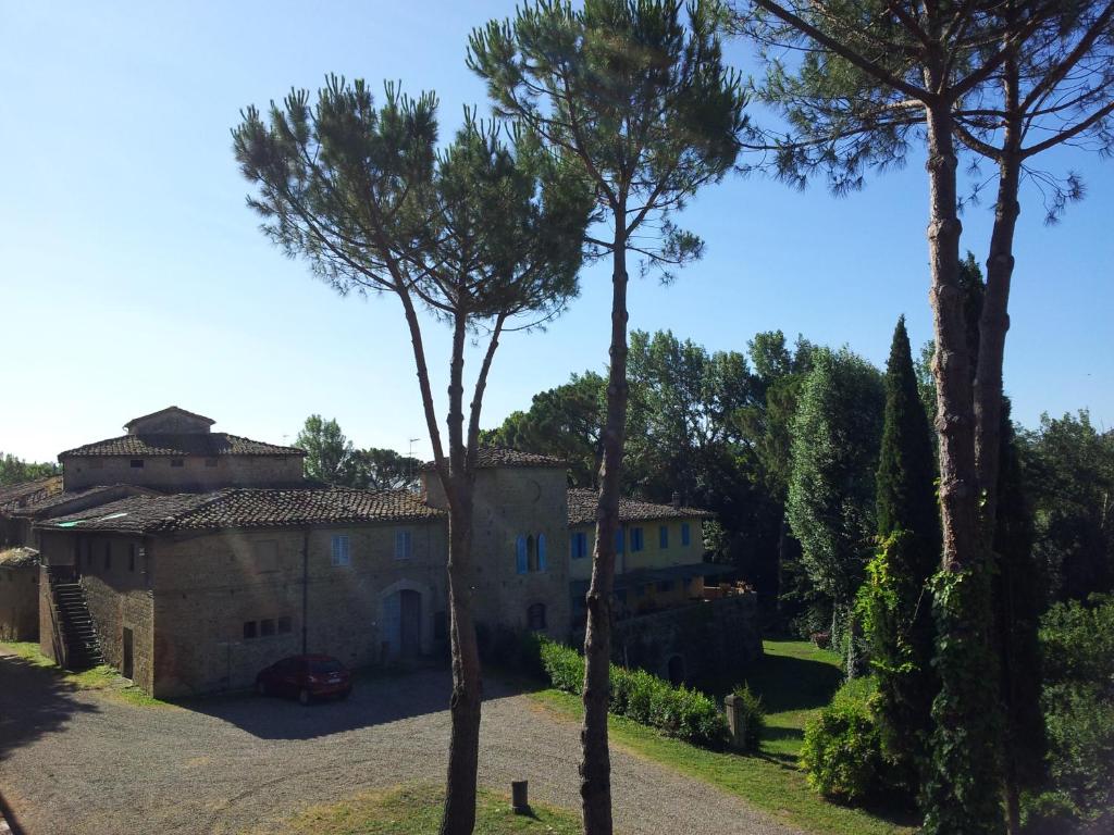 a house with trees in front of it at Bassetto Guesthouse & Apartments in Certaldo