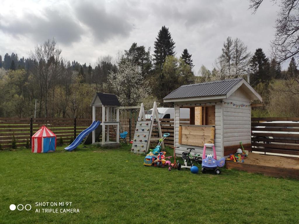 a backyard with a play house and a playground at Gościnna Chata in Jaworki