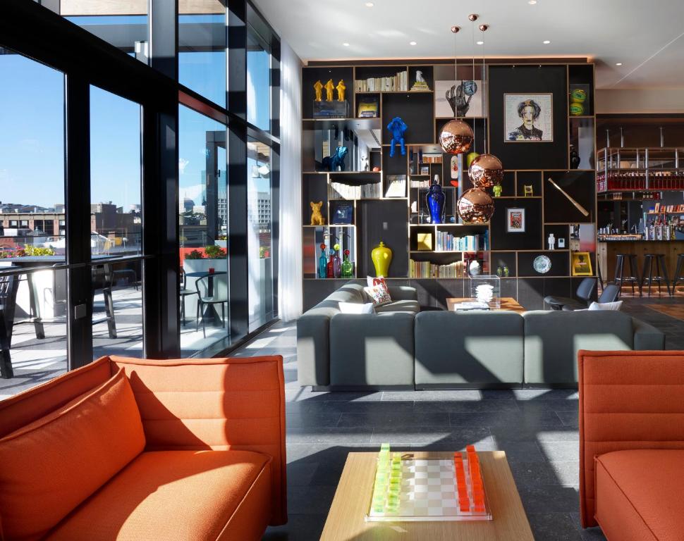 a living room with a couch and a table at citizenM Boston North Station in Boston