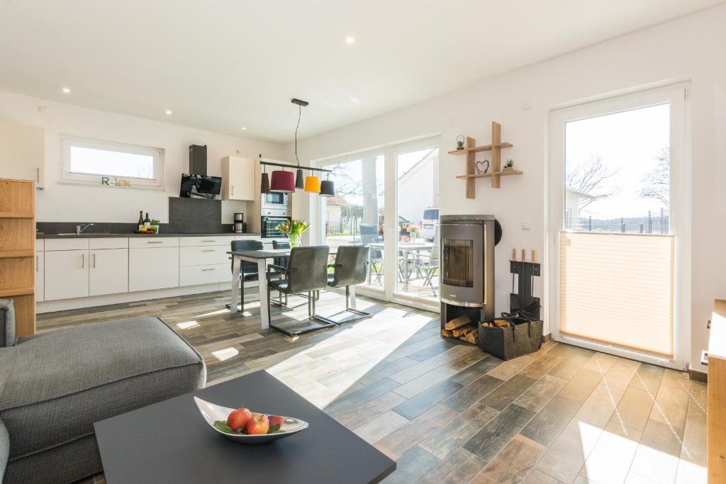 a living room with a couch and a table at Neu!!! Ferienhaus-See-Sauna-Kamin-5 Sterne-102m² in Krakow am See