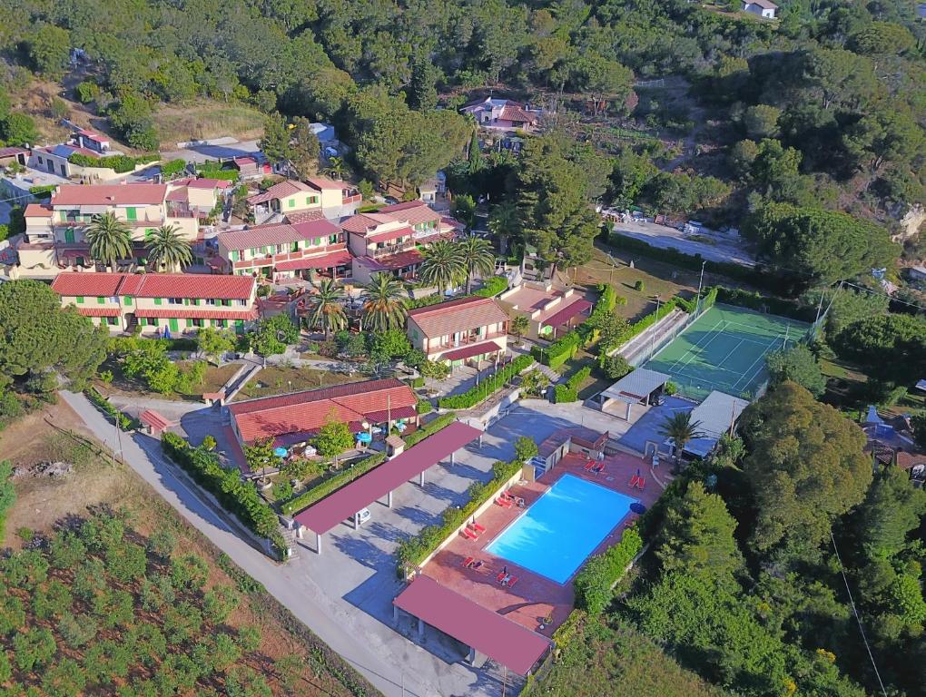 an aerial view of a house with a tennis court at Residence La Valdana in Capoliveri
