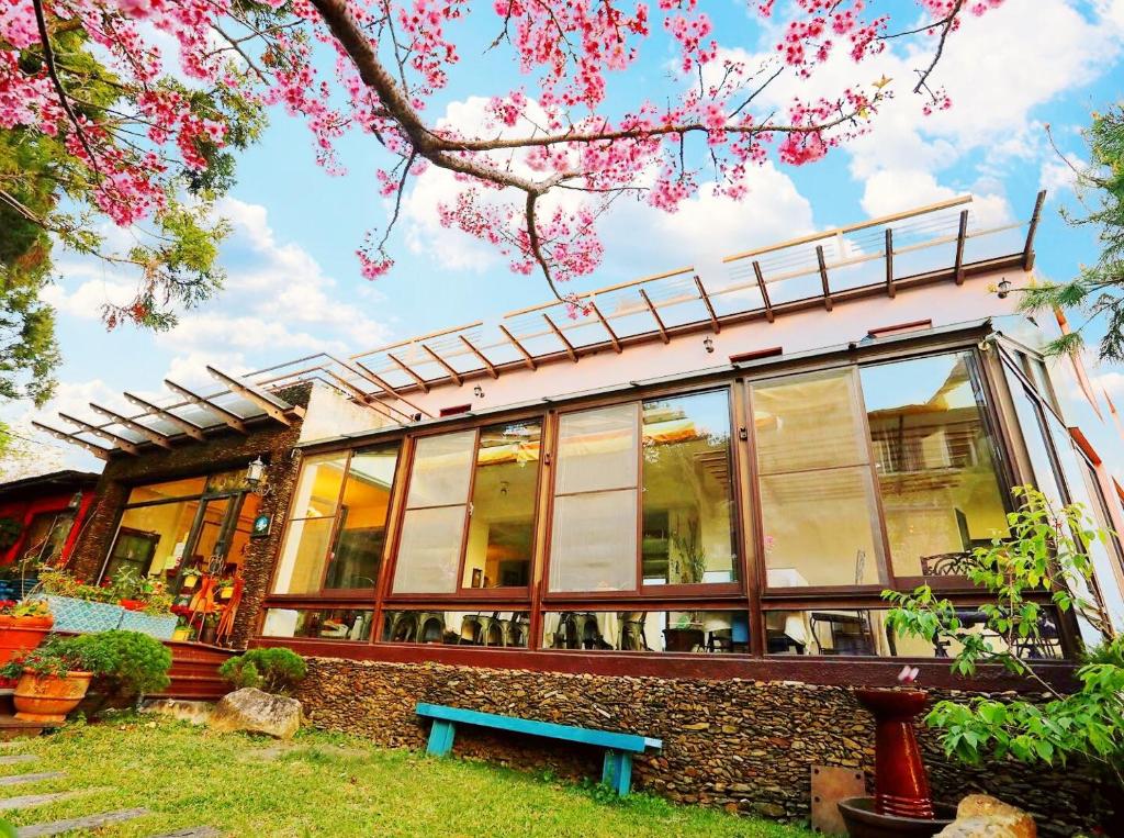 a house with a blue bench in front of it at Margaret Garden Villa in Ren&#39;ai