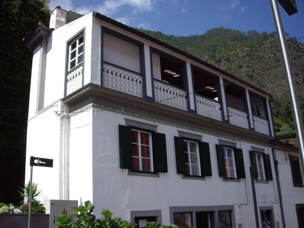 a white building with a balcony on top of it at Holidays Madeira in São Vicente