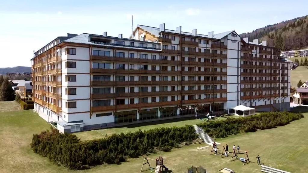 a large building with people standing in front of it at Apartmán Bella Donovaly v hotelovom komplexe in Donovaly