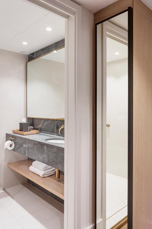 a bathroom with a sink and a mirror at Copenhagen Admiral Hotel in Copenhagen