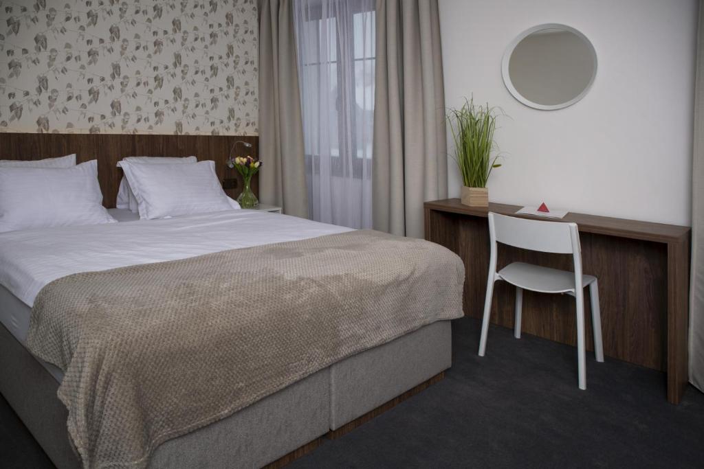 Postel nebo postele na pokoji v ubytování Hotel Prichovice