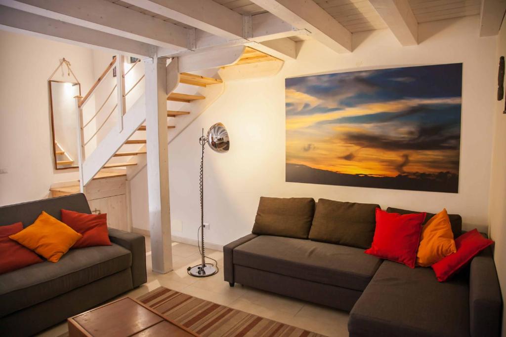 a living room with a couch and a staircase at Naturalmente abitare in Catania