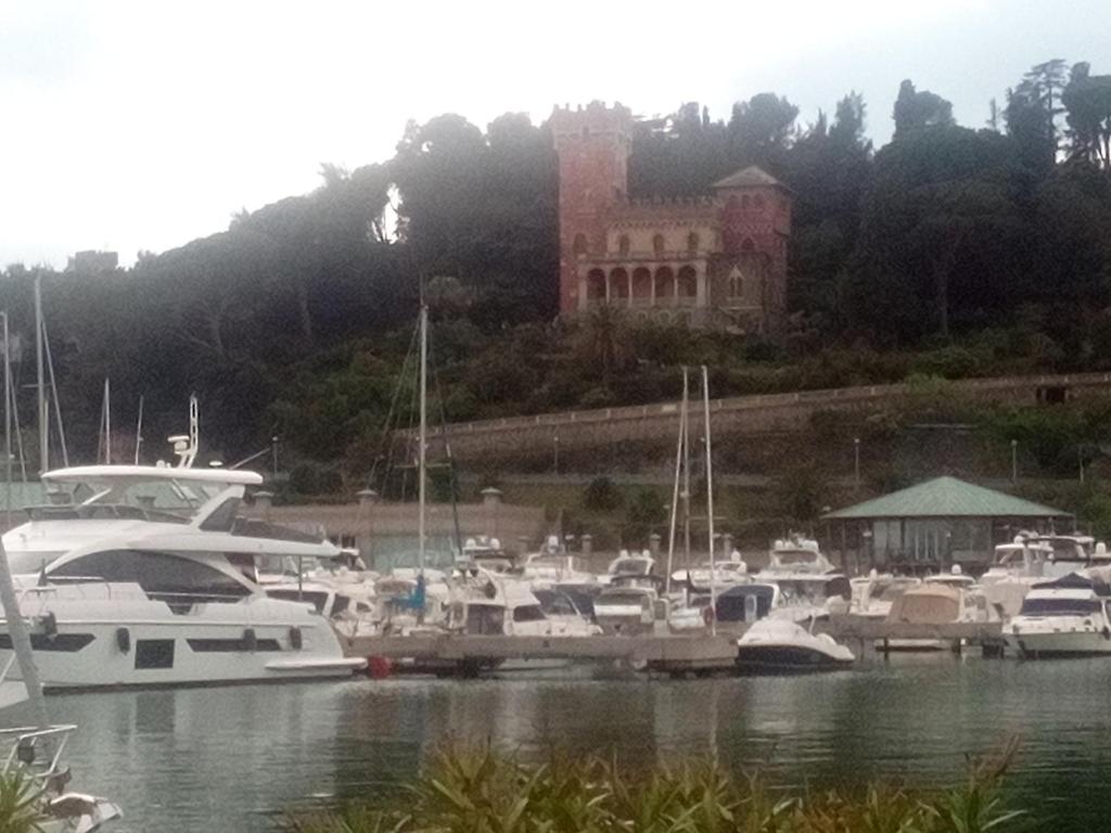a bunch of boats docked in a marina with a large building at Jokabi in Varazze