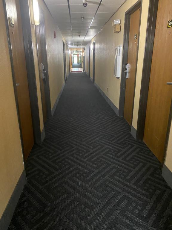 a hallway in a building with a carpeted floor at Super 8 by Wyndham Maysville KY in Maysville