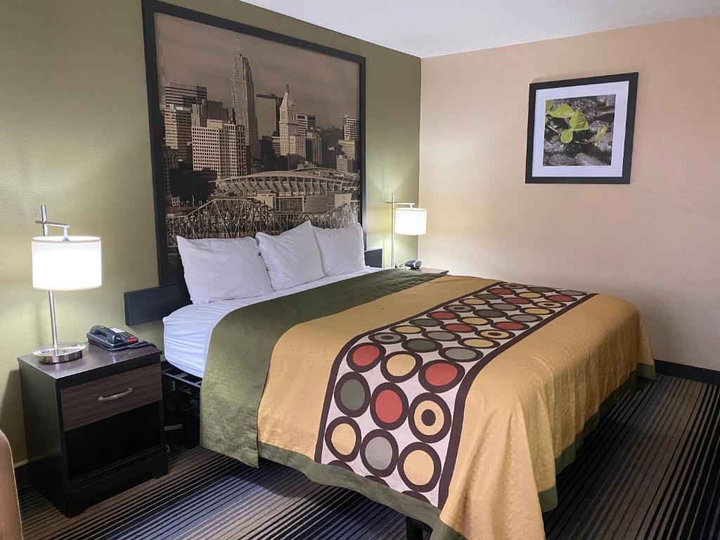 a hotel room with a large bed in a room at Super 8 by Wyndham Maysville KY in Maysville