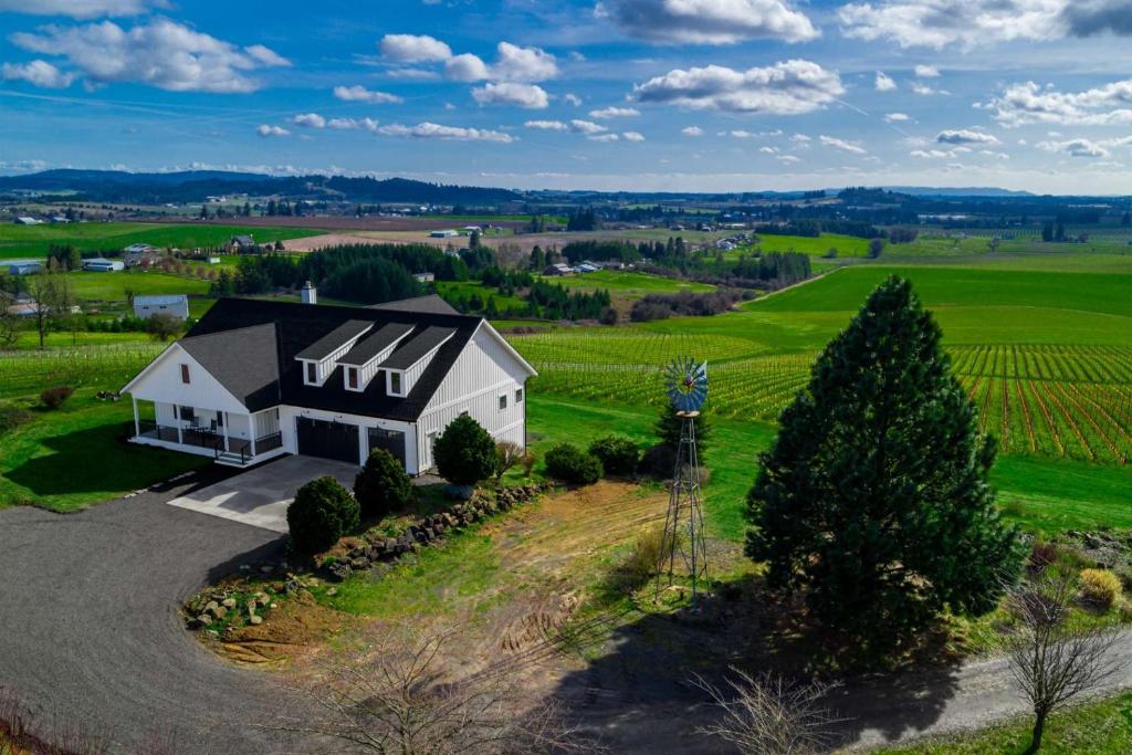an aerial view of a white house in a field at The Gables at Quandary Vineyards in Yamhill