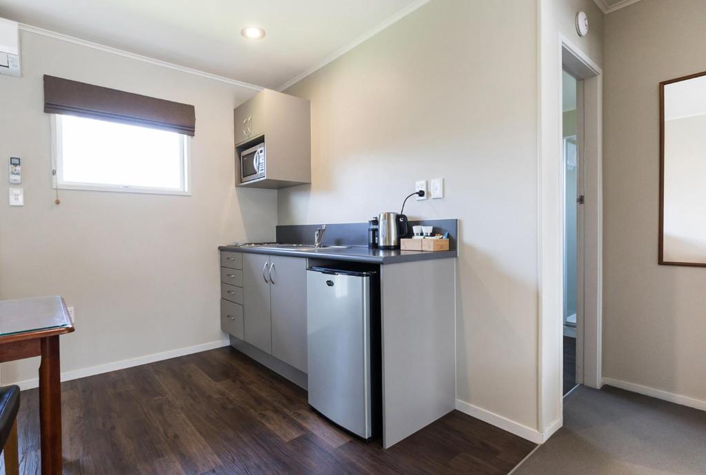a kitchen with a sink and a counter top at Colonial Court Motor Inn in Tauranga
