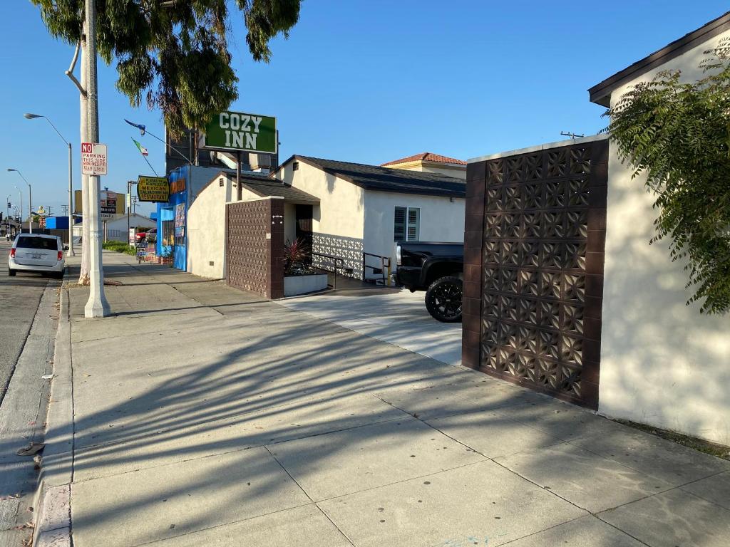 a street with a pick up truck parked next to a building at Cozy motel in Lynwood