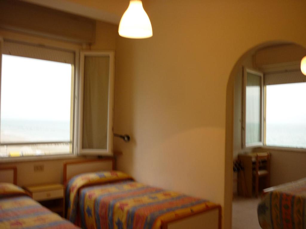 Postel nebo postele na pokoji v ubytování Hotel Oasi Ristorante Pizzeria