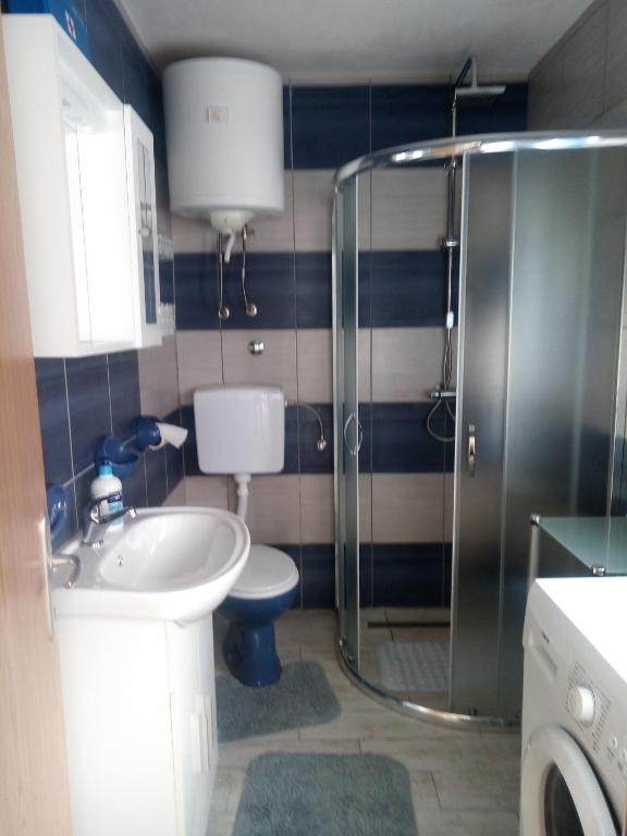 a bathroom with a toilet and a sink and a shower at KATY&MLADEN in Baška