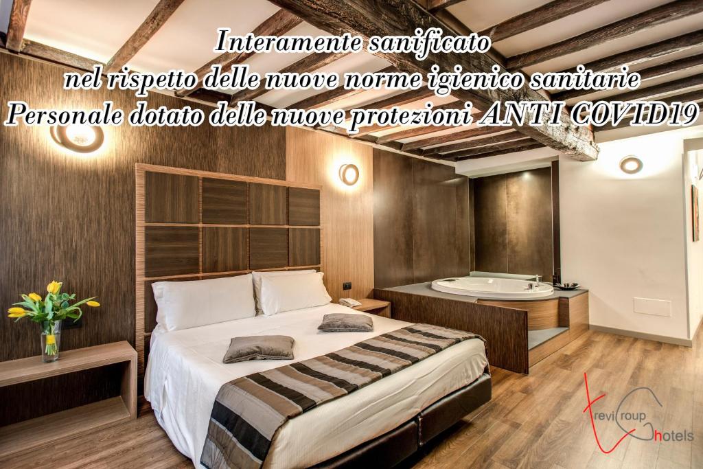 
a hotel room with a bed, desk and a lamp at Hotel Trevi - Gruppo Trevi Hotels in Rome
