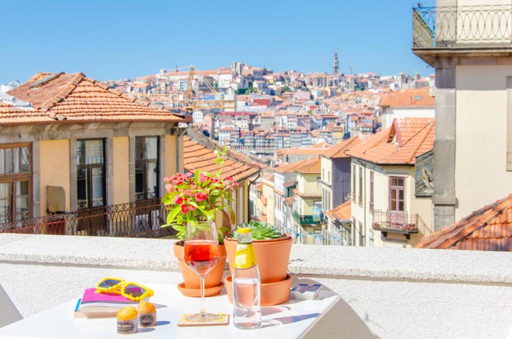 a table on a balcony with a view of a city at Porto Moments Apartments by Portugal Collection in Vila Nova de Gaia