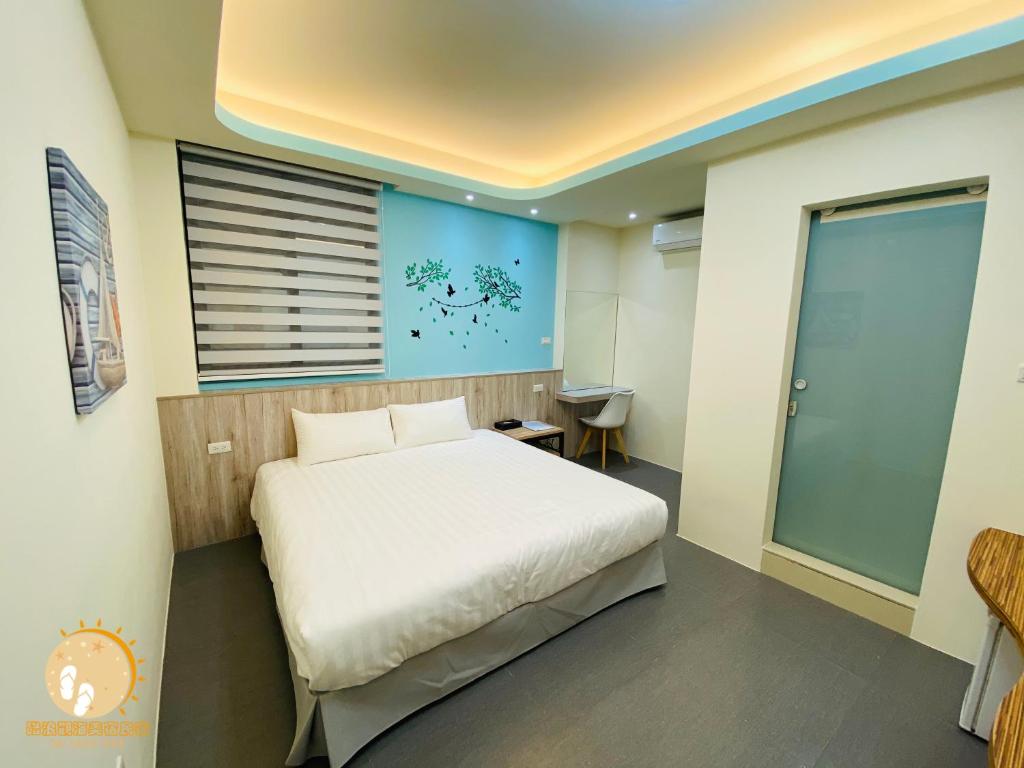 Postel nebo postele na pokoji v ubytování Ta Lang Guan Hai Mei Su B&B