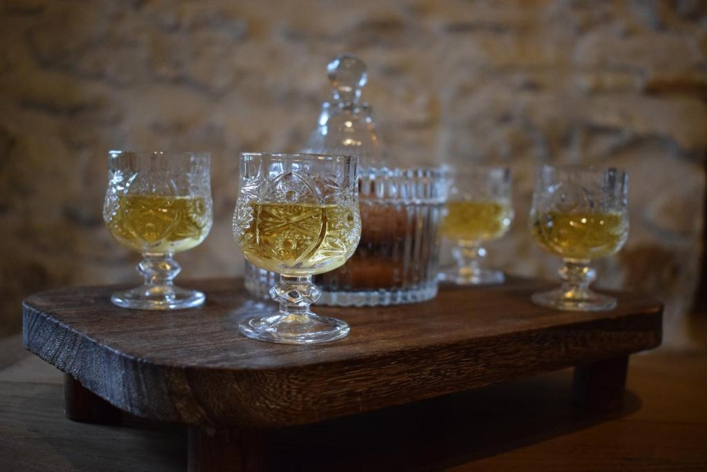 a group of wine glasses on a wooden table at Latmos 1860 in Skala