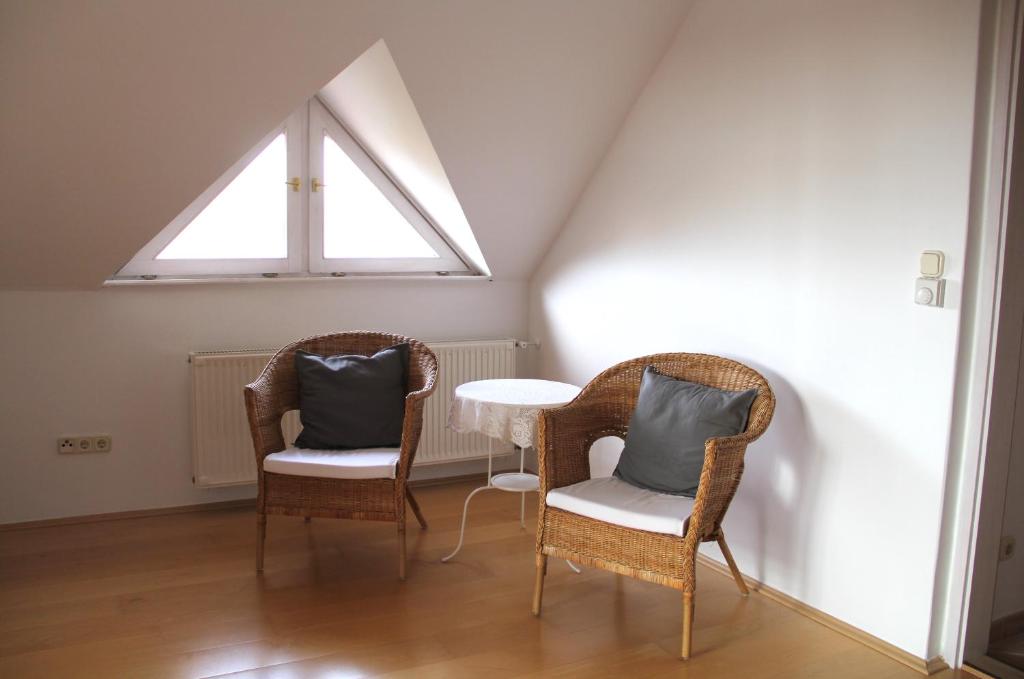 two chairs and a table in a room with a window at ALPHA in Badacsonytördemic