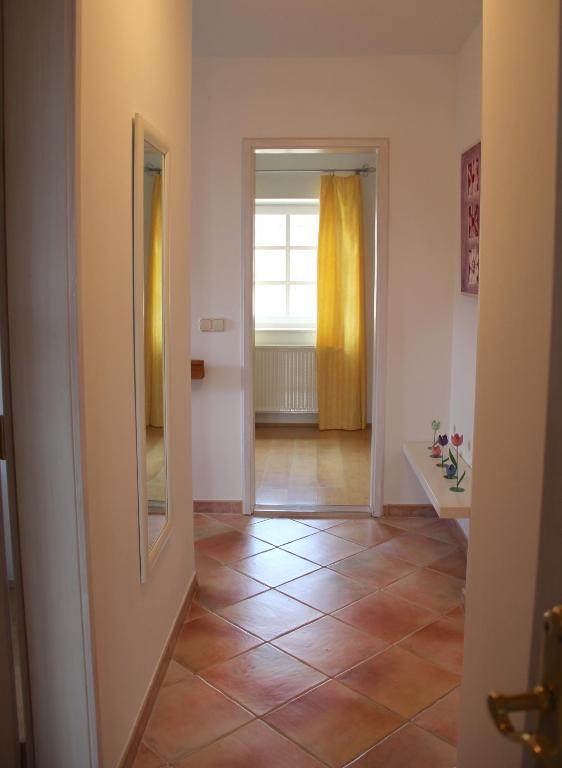 a hallway with a tile floor and a window at ALPHA in Badacsonytördemic