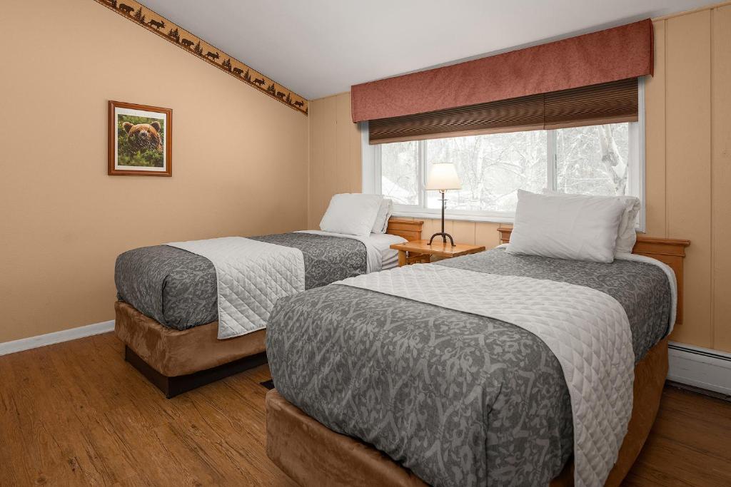 a hotel room with two beds and a window at Chena Hot Springs Resort in Chena Hot Springs