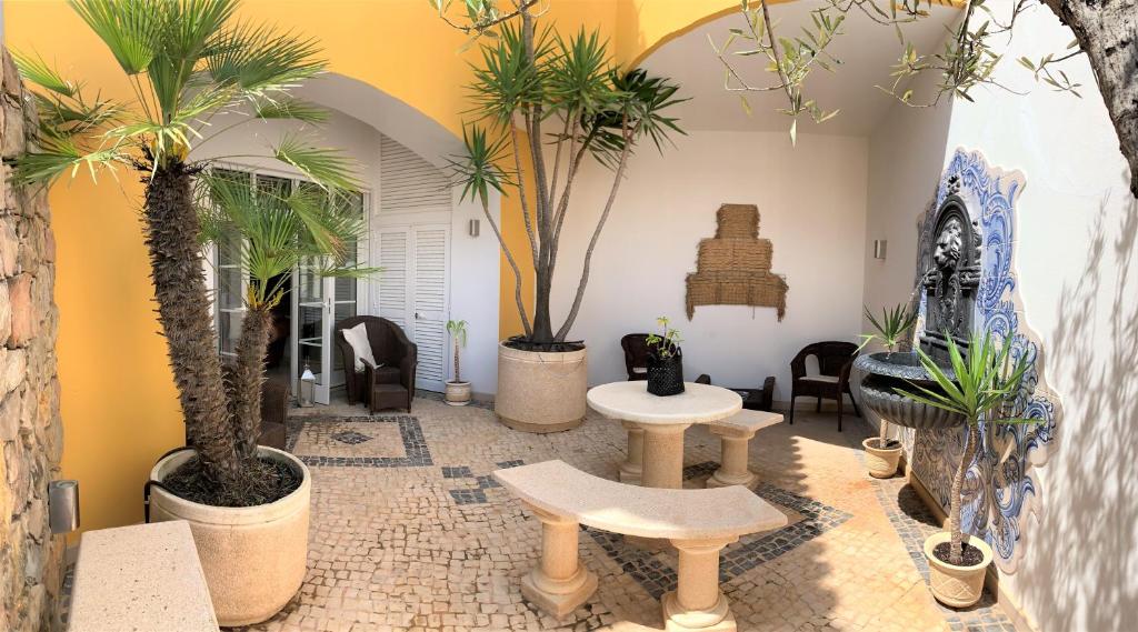 a room with potted plants and tables and chairs at Residence Lagos in Lagos