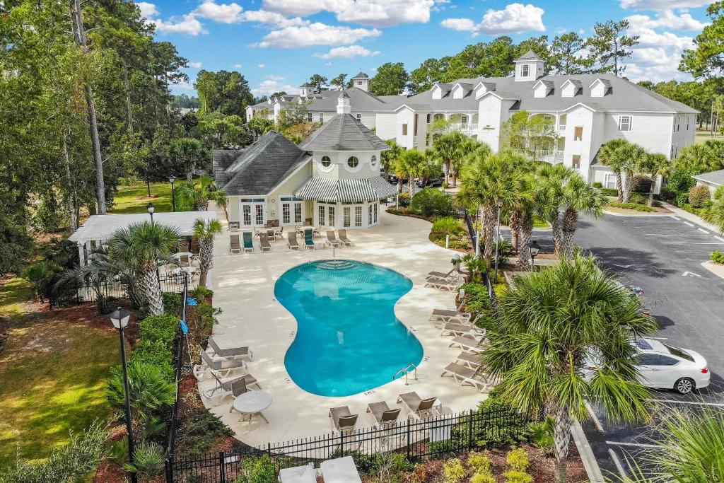 an aerial view of a resort with a pool and chairs at Grande Villas at World Tour Golf Resort in Myrtle Beach