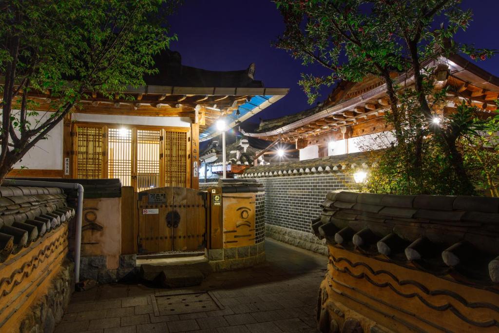 a building with a gate in front of it at night at GaEunChae in Jeonju