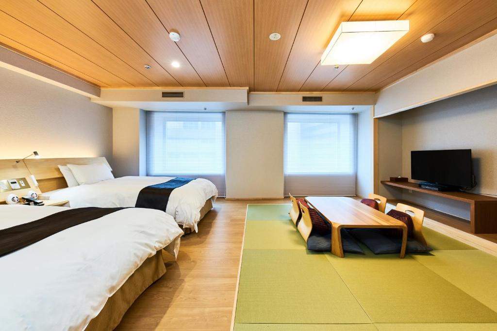 a hotel room with two beds and a tv at Hotel Tokyo Garden Palace in Tokyo