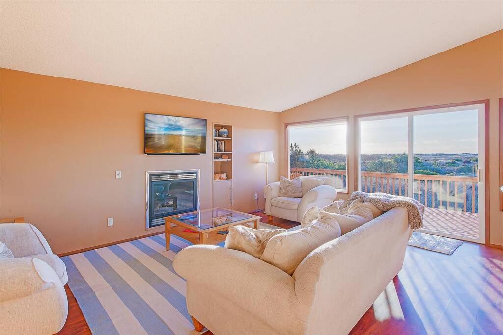 a living room with a couch and a fireplace at Ocean Trails Getaway in Ocean City