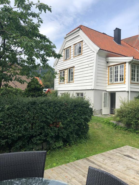 a white house with a red roof at Stryn - house by the river in Stryn