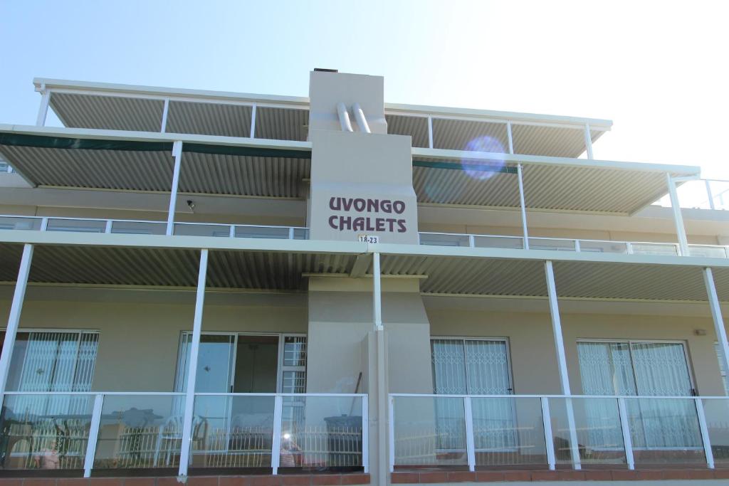 a building with a sign that reads universal carriers at Uvongo Chalet 11 in Margate