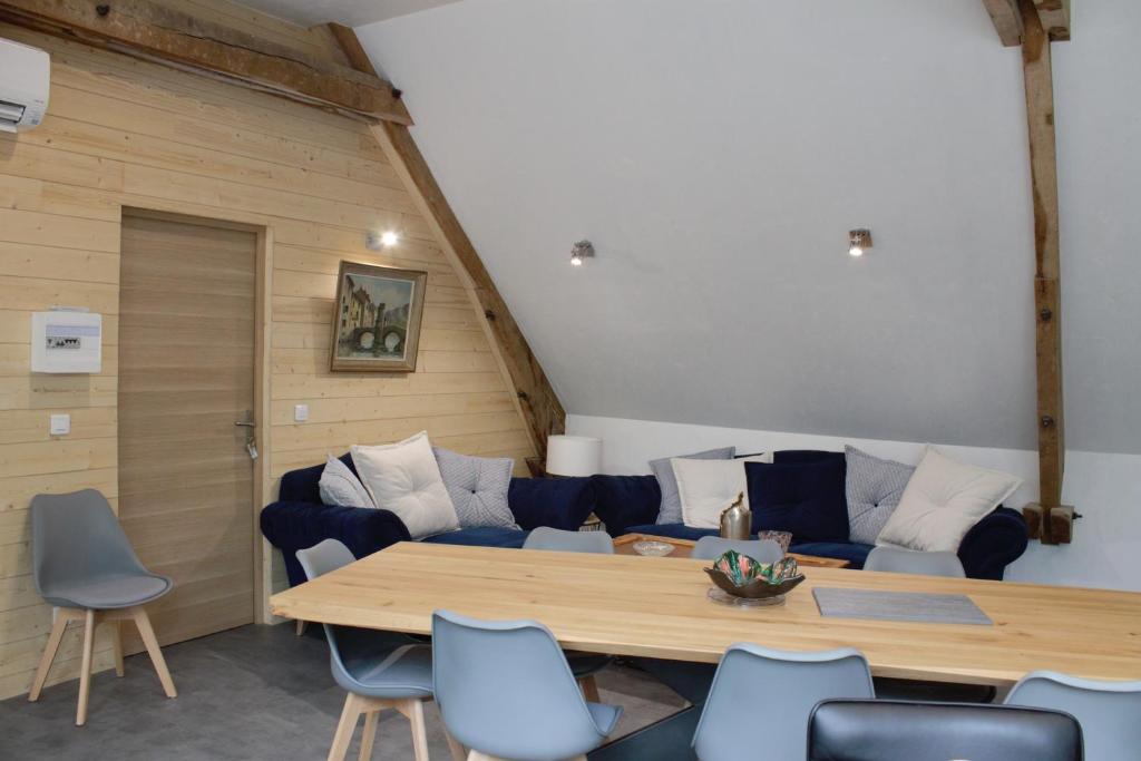 a living room with a couch and a table and chairs at chambres d’hôte le breuil in Sarlat-la-Canéda