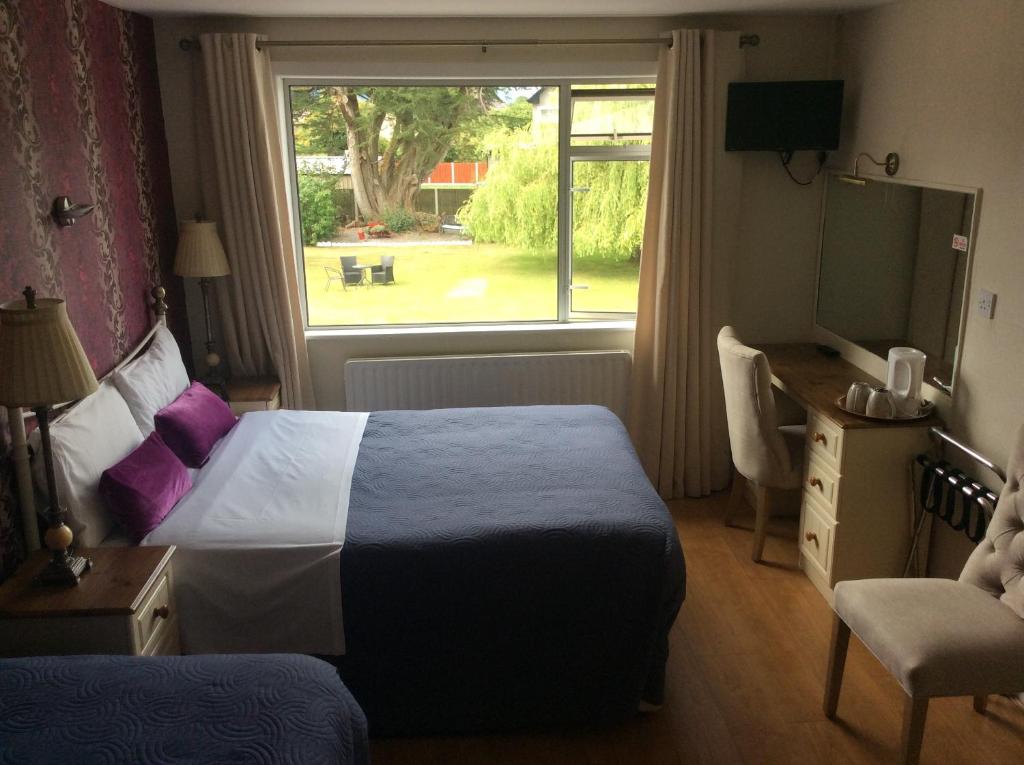 a hotel room with a bed and a window at The Gardens guest accommodation in Killarney