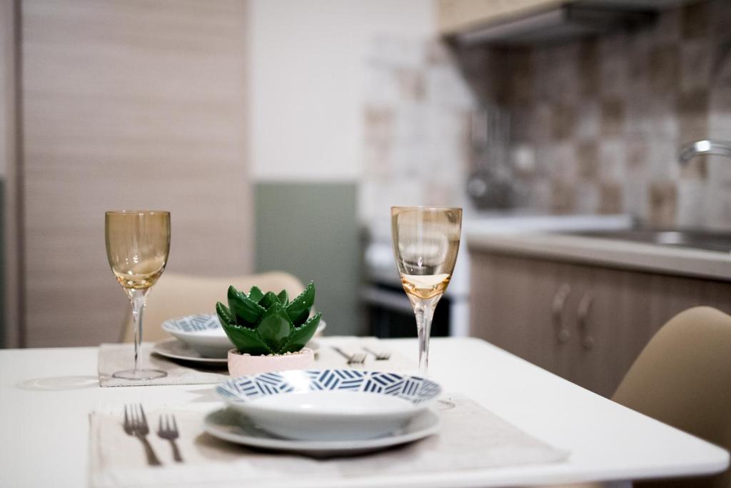 a table with two glasses of wine on a table at Christi Iuxury Apartment in Preveza