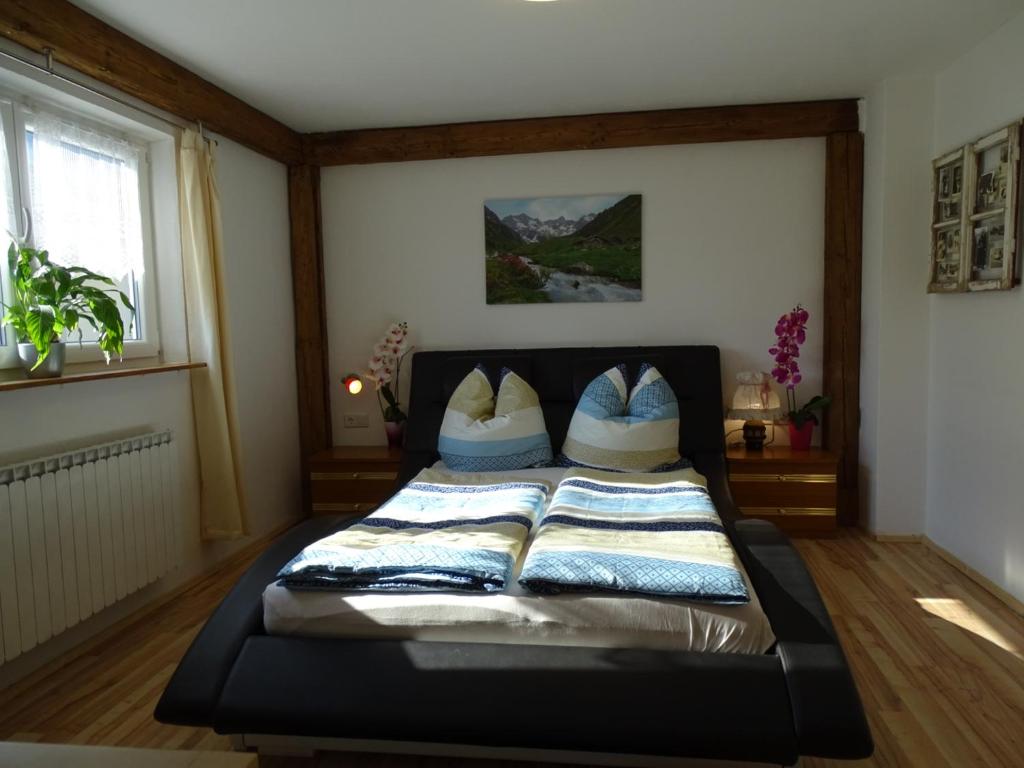 a bedroom with a bed with pillows on it at Ferienwohnung Anna in Inzell