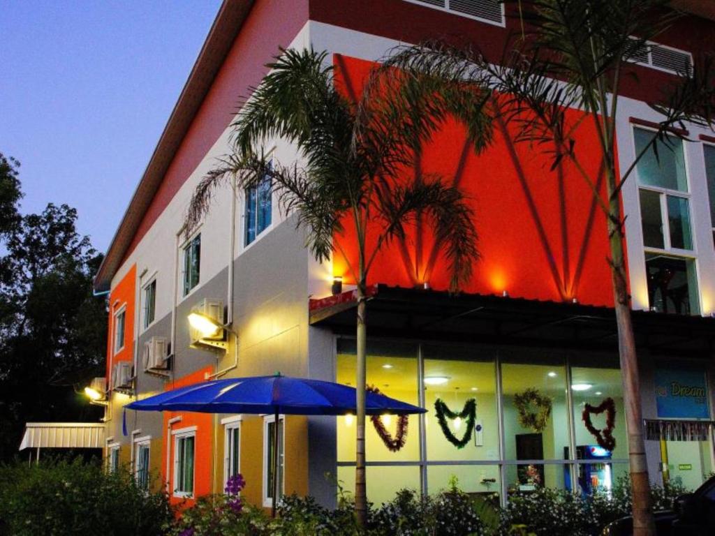 a blue umbrella in front of a building at Na Dream Place in Suratthani