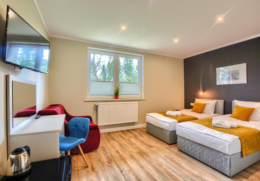 Postel nebo postele na pokoji v ubytování SPA & RESORT BUKOWIEC