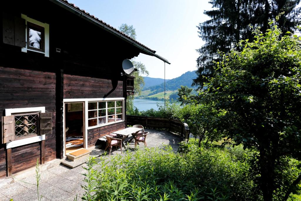 a patio with a table and chairs next to a house at Schlierseehaus in Schliersee