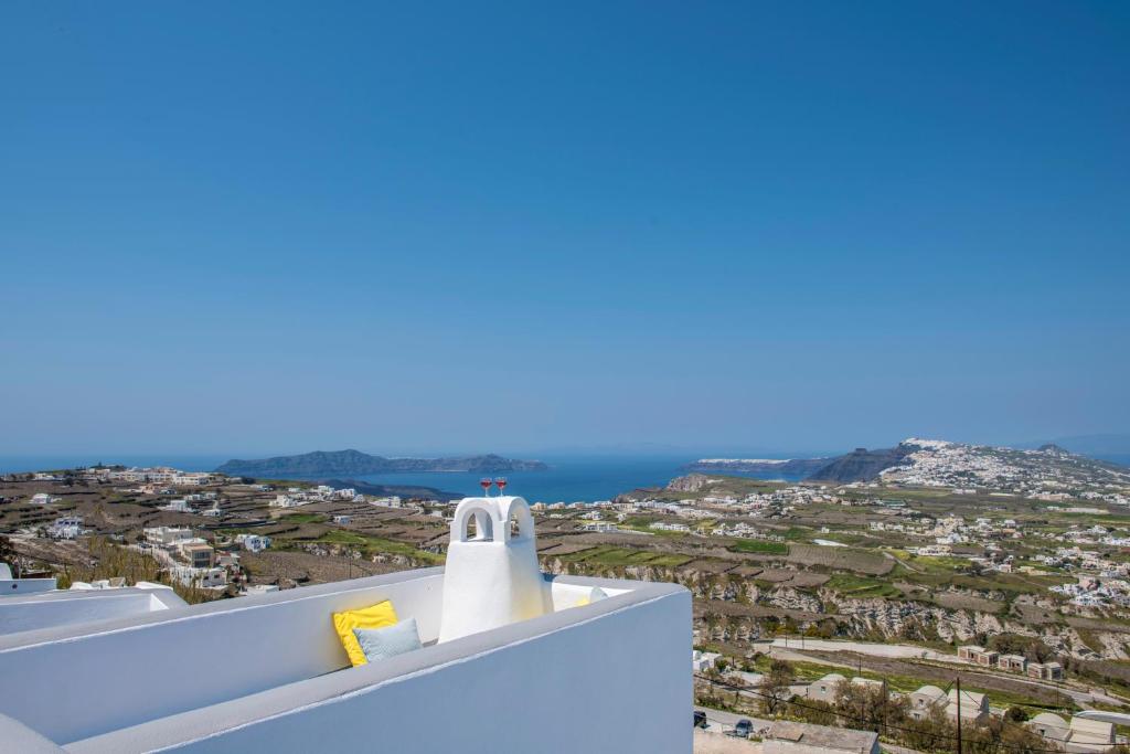 a view of the city from the roof of a house at Santorini 180 Degrees in Pyrgos